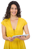 Cheerful casual young woman using her tablet computer