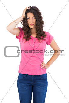 Nervous cute brunette posing