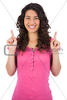 Smiling brown haired woman pointing out
