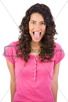 Disgusted long haired brunette sticking her tongue out
