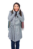 Surprised brunette wearing winter clothes posing