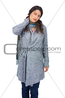 Pretty brunette wearing winter clothes touching her painful neck