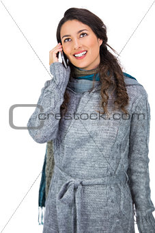 Pretty brunette wearing winter clothes on the phone