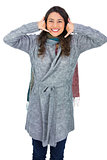 Happy model with winter clothes making phone call gesture