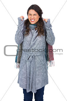 Angry pretty model with winter clothes posing