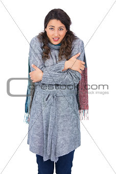 Uneasy pretty model with winter clothes being cold