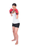 Serious young model in sportswear boxing