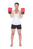 Angry healthy model with boxing gloves posing