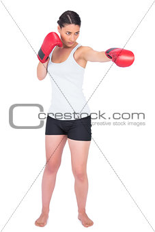 Slender model with boxing gloves punching