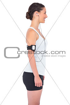 Profile view of smiling fit model going to run