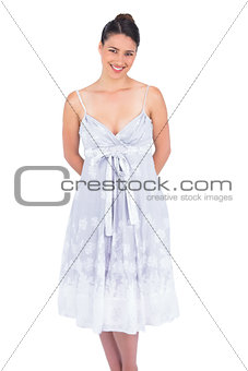 Smiling seductive young model in summer dress posing