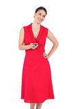 Happy elegant brunette in red dress texting