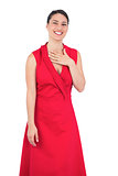 Smiling elegant model in red dress posing