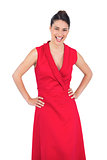 Happy elegant model in red dress posing