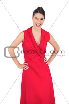 Happy elegant model in red dress posing