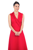 Curious elegant model in red dress posing