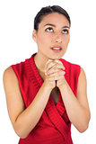 Beautiful brunette in red dress praying