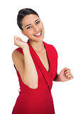 Cheerful sexy brunette in red dress gesturing