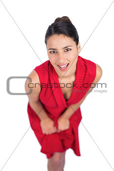 Content mysterious brunette in red dress posing