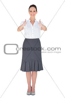 Cheerful businesswoman posing thumbs up