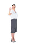 Elegant businesswoman showing an okay gesture