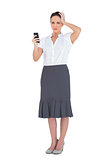 Worried businesswoman holding her phone
