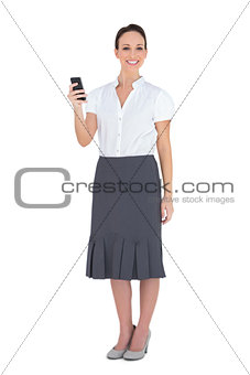 Smiling businesswoman holding her phone