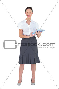 Cheerful businesswoman holding tablet computer