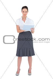 Serious businesswoman using tablet computer