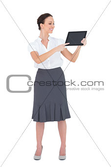 Cheerful businesswoman showing something on her tablet pc