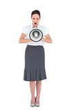 Angry businesswoman shouting in her megaphone