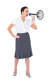 Stern businesswoman shouting in her megaphone