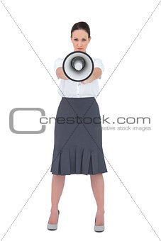 Stern businesswoman holding her megaphone