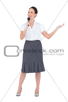 Cheerful presenter holding microphone