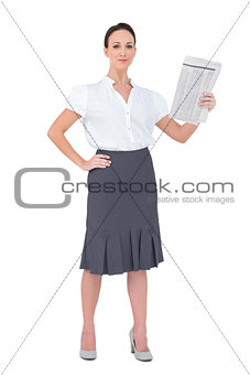 Peaceful stylish businesswoman holding newspaper