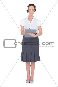 Concentrated call center agent holding clipboard