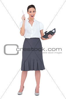 Surprised businesswoman holding her datebook