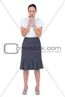 Relaxed businesswoman smelling coffee