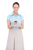 Cheerful classy young businesswoman sending text message