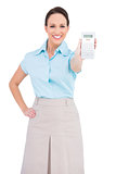 Smiling classy businesswoman showing calculator