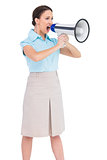 Angry classy businesswoman shouting in her megaphone