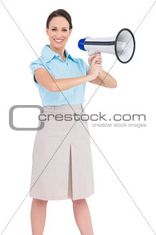 Cheerful classy businesswoman holding megaphone