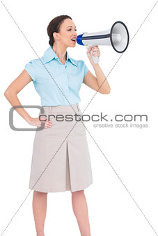 Peaceful classy businesswoman talking in megaphone