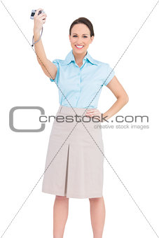 Cheerful classy businesswoman taking picture of herself