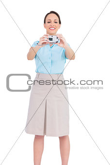 Happy classy businesswoman taking picture of herself