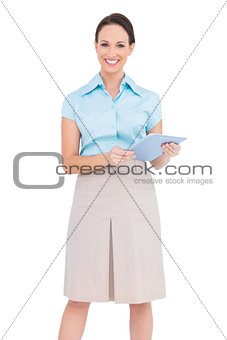 Happy young businesswoman holding tablet pc