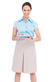 Cheerful young businesswoman holding tablet pc