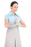 Peaceful young businesswoman praying