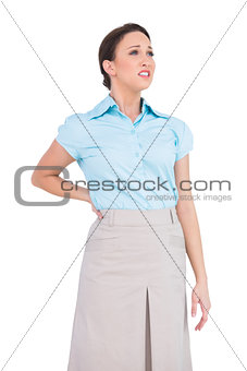 Pretty businesswoman suffering from painful back