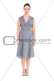Elegant brunette in classy dress posing